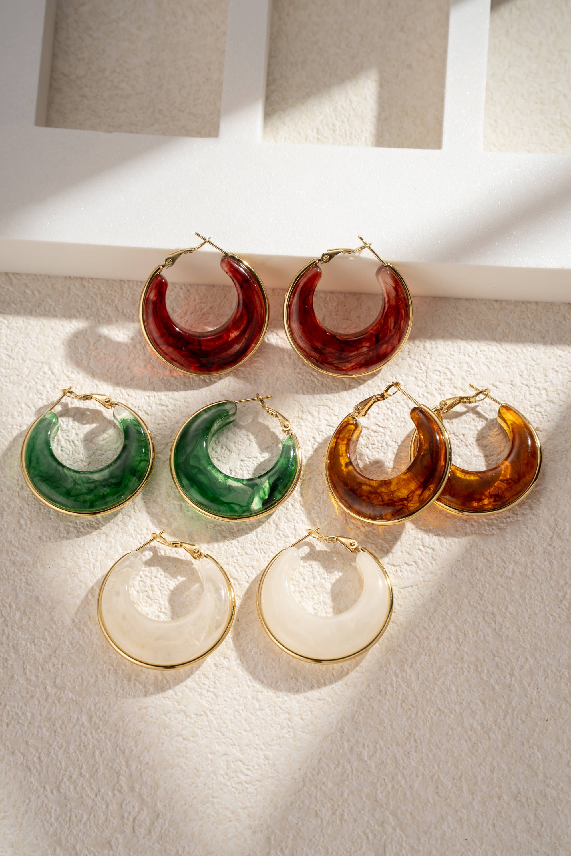 Boho Studio marbled resin half-moon hoop earrings set with gold-tone rims