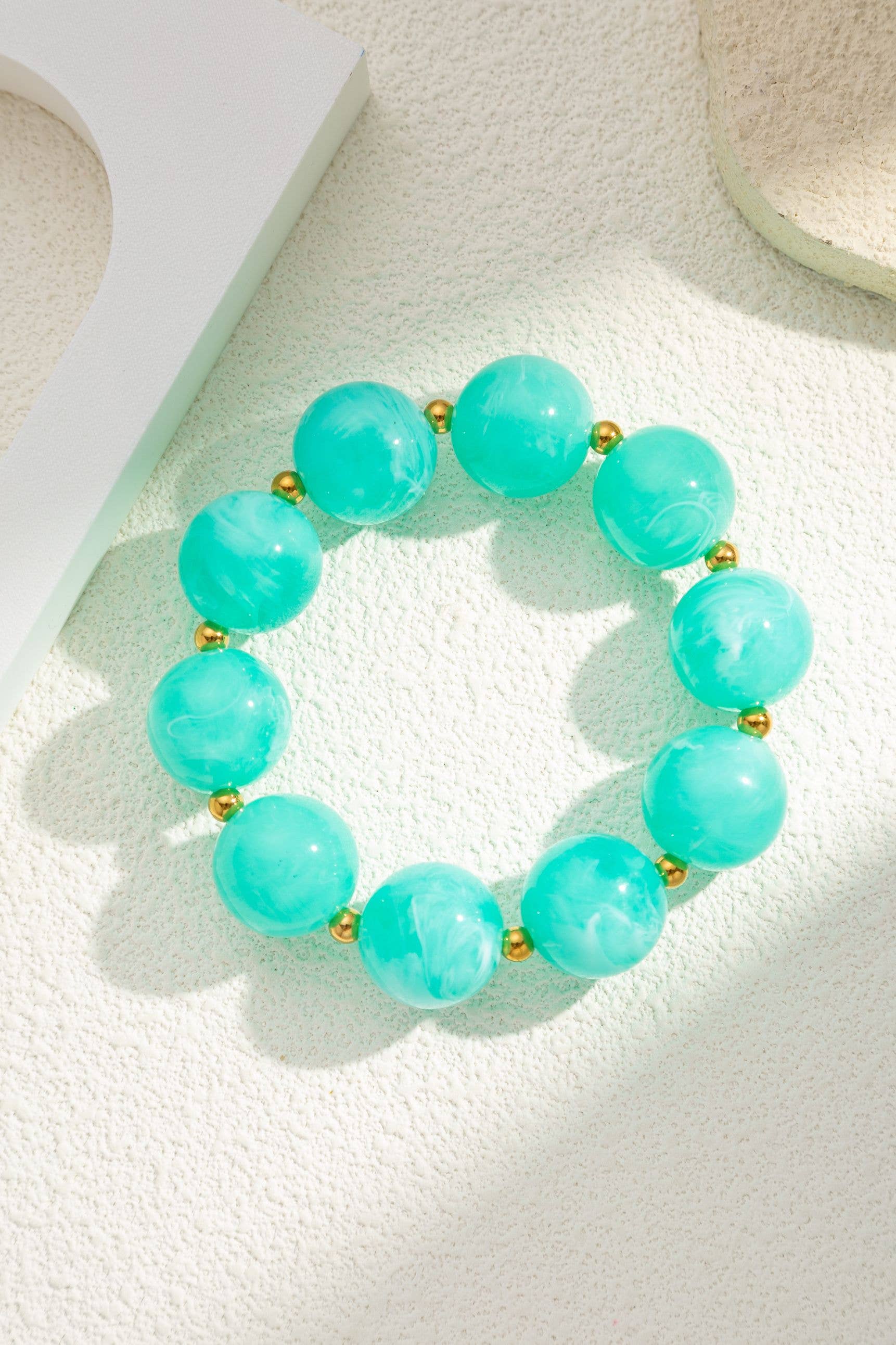 Marbled resin bead bracelet with gold steel spacers by Boho Studio
